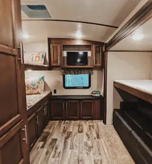 Kids bunk room features 3 twin bunks and a pullout couch.